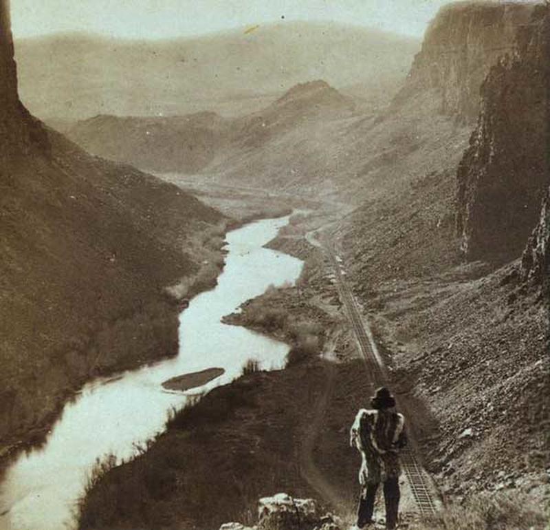 1868, A native American looking over the newly completed transcontinental railroad in Nevada