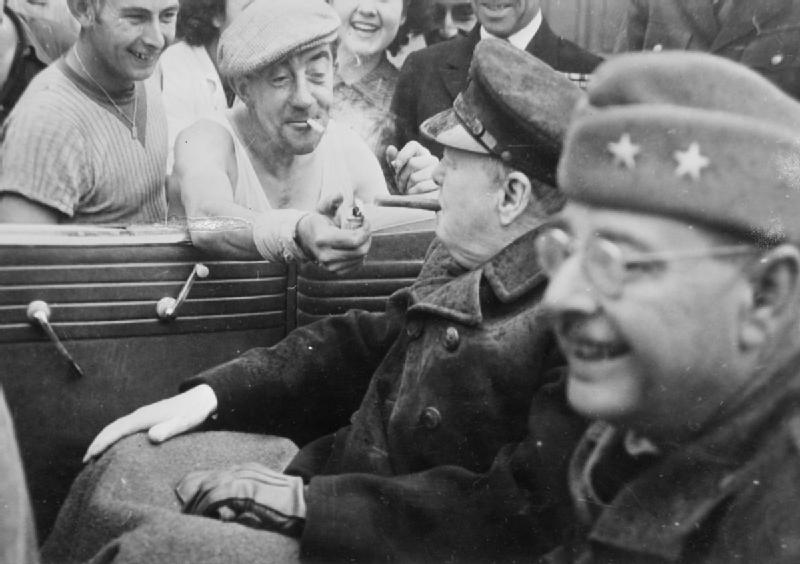 1944, A newly liberated French citizen lights Winston Churchill's cigar with enthusiasm